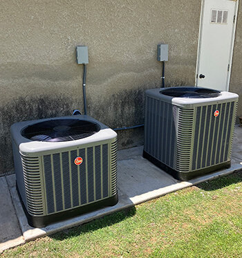 Two air conditioning units outside of a client building